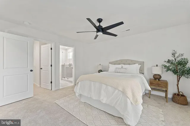 a spacious bedroom with a bed and a window