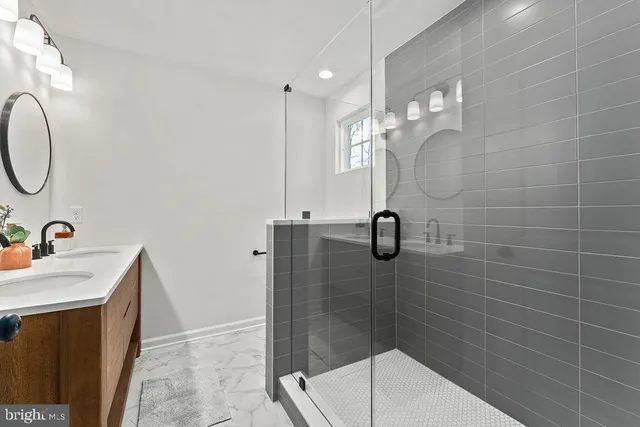 a bathroom with a sink a mirror and shower