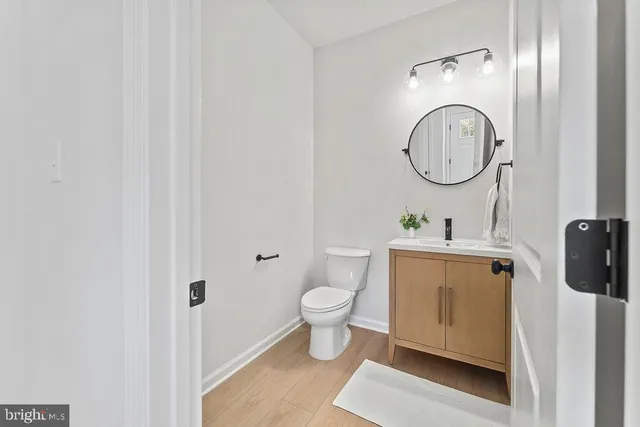 a bathroom with a toilet sink and a mirror