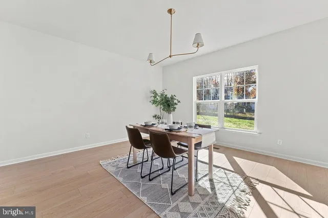a view of a dining room with furniture and window