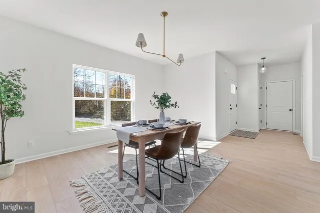 a view of a dining room with furniture and window