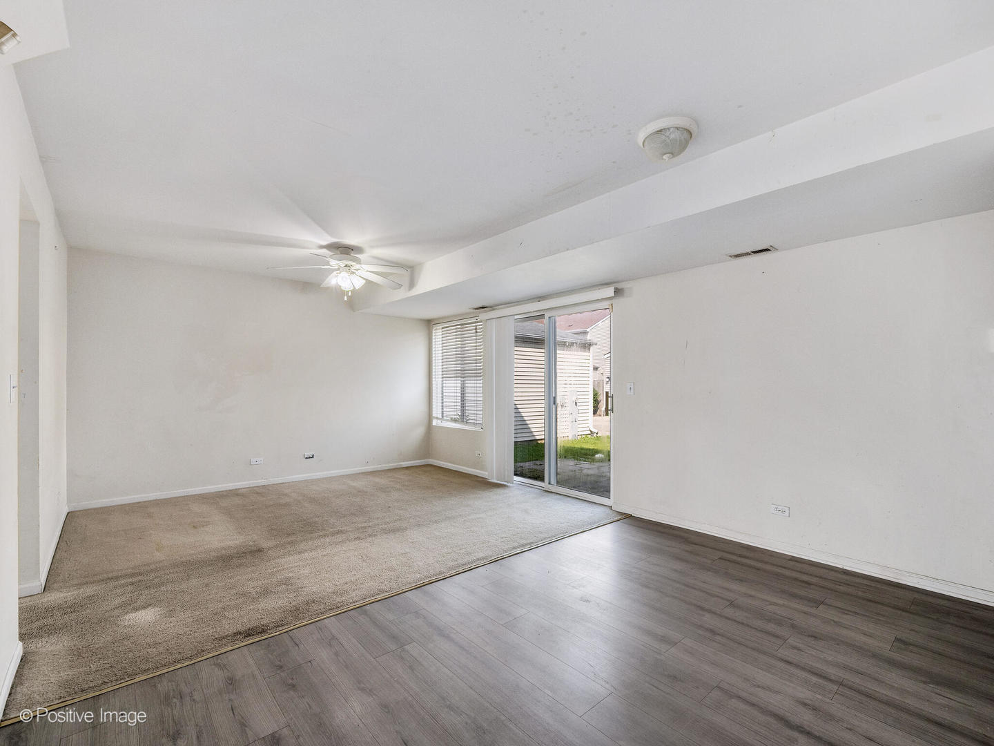 948 Symphony Drive Aurora, IL 60504 - Photo 11 of 22 a view of an empty room with wooden floor and a window