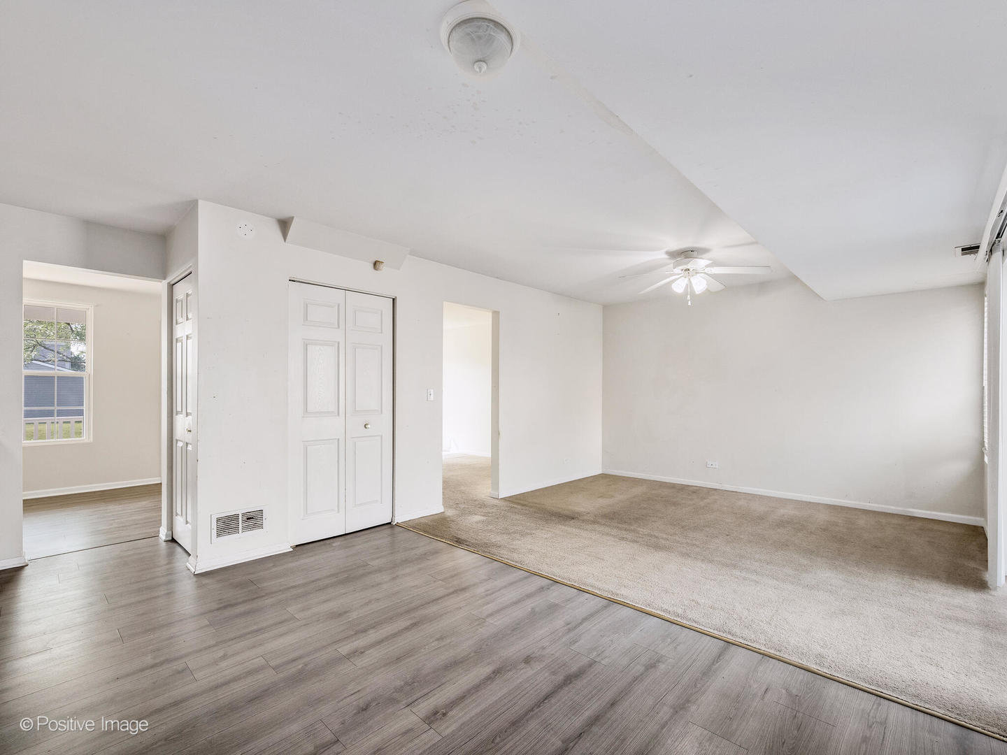 948 Symphony Drive Aurora, IL 60504 - Photo 12 of 22 an empty room with wooden floor and windows