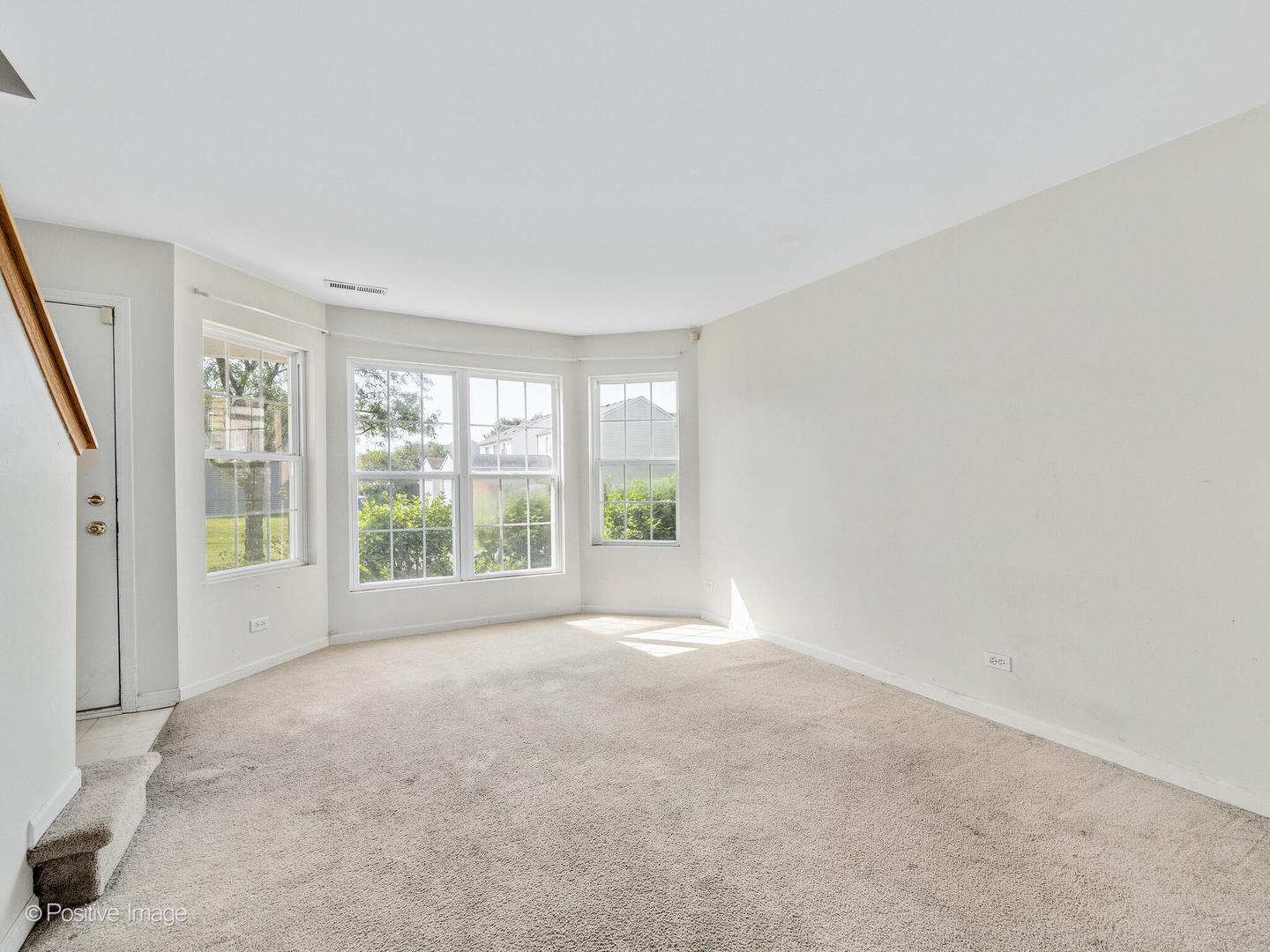 948 Symphony Drive Aurora, IL 60504 - Photo 4 of 22 a view of a big room with windows and chandelier fan