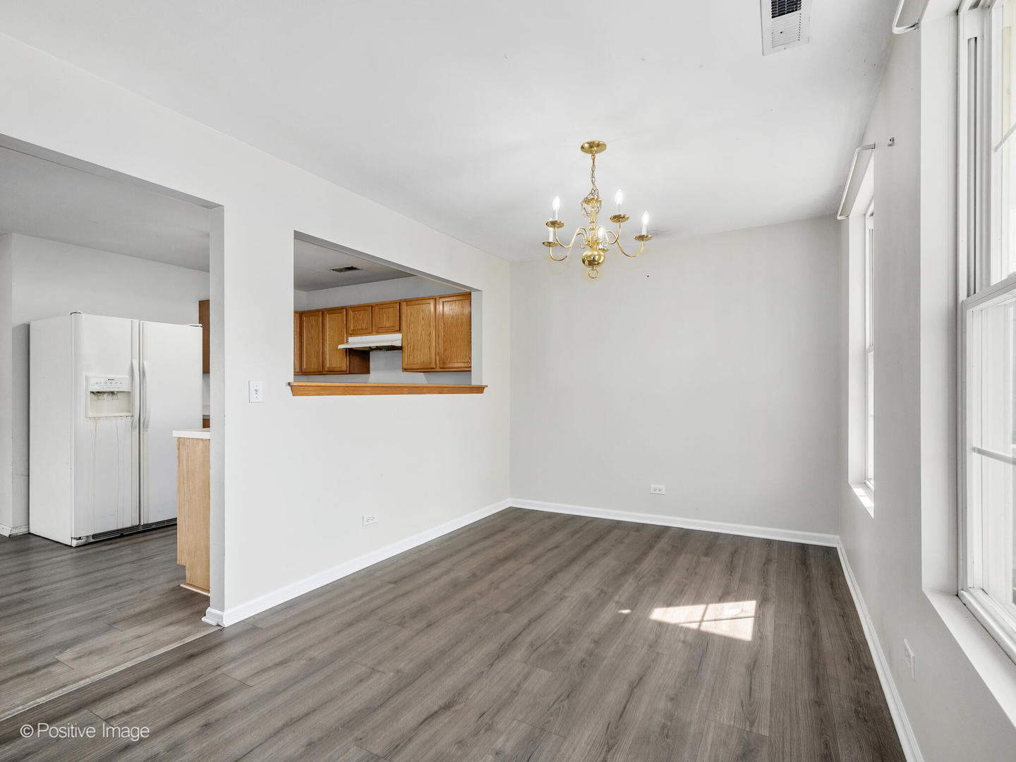 948 Symphony Drive Aurora, IL 60504 - Photo 6 of 22 wooden floor in an empty room with a window