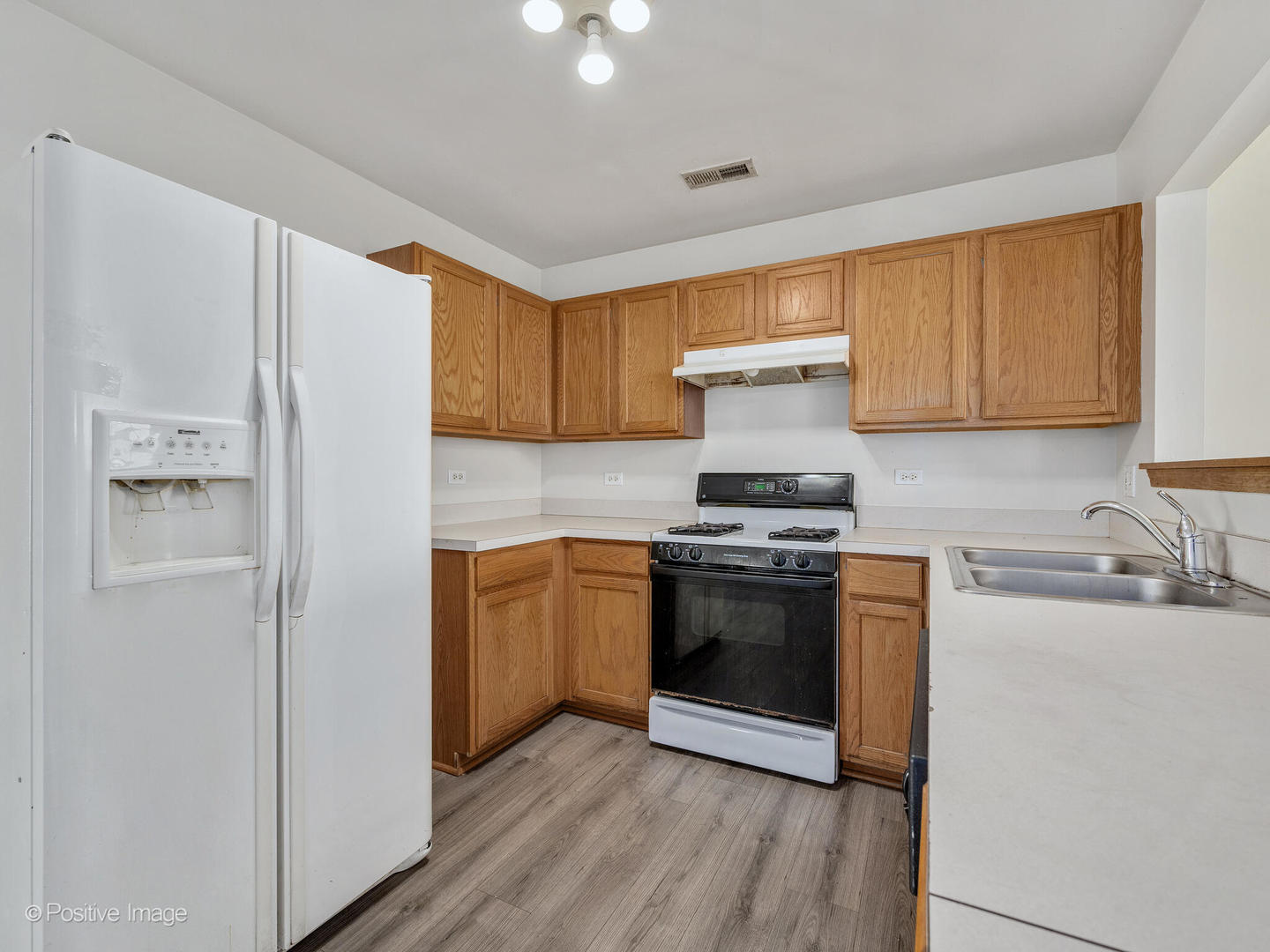 948 Symphony Drive Aurora, IL 60504 - Photo 9 of 22 a kitchen with stainless steel appliances granite countertop a stove a sink and a refrigerator