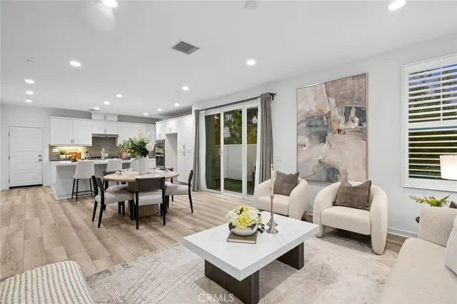 a living room with furniture and view of kitchen