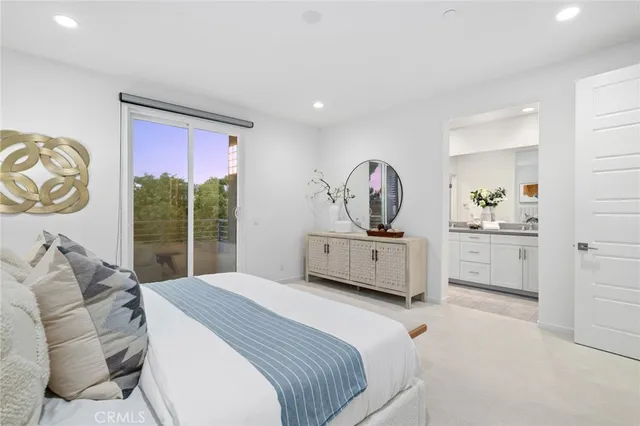 a bedroom with a bed a dresser and next to a window