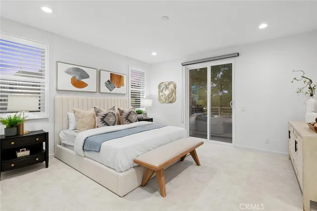 a spacious bedroom with a bed and a window