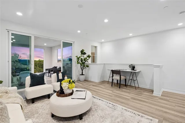 a living room with furniture and a dining table