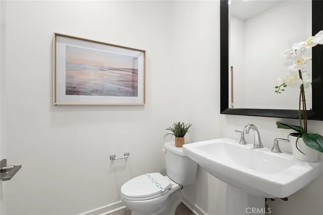 a bathroom with a toilet a sink and a mirror