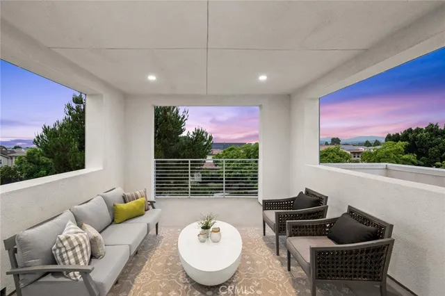 a living room with furniture and a floor to ceiling window