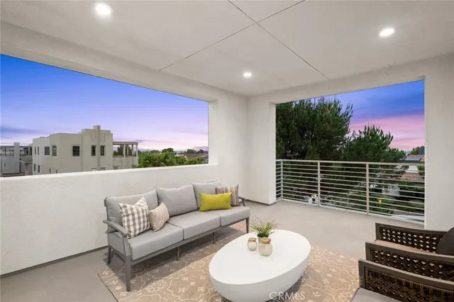 a balcony with furniture and a garden