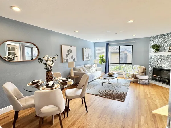 a living room with fireplace furniture and a wooden floor