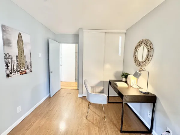 a view of a room with furniture and wooden floor
