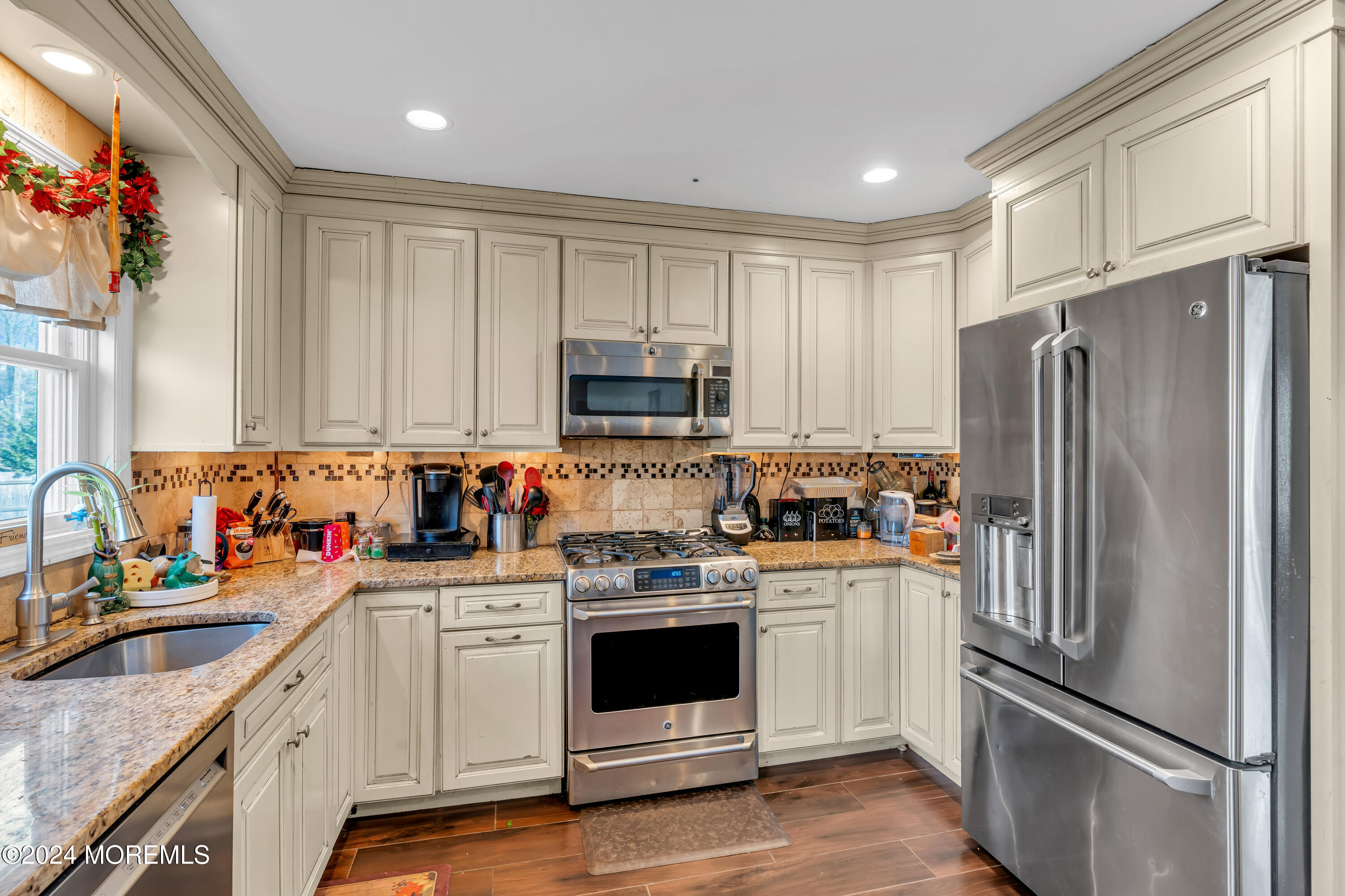 50 Hawthorne Road Middletown, NJ 07701 - Photo 11 of 33 a kitchen with white cabinets and stainless steel appliances