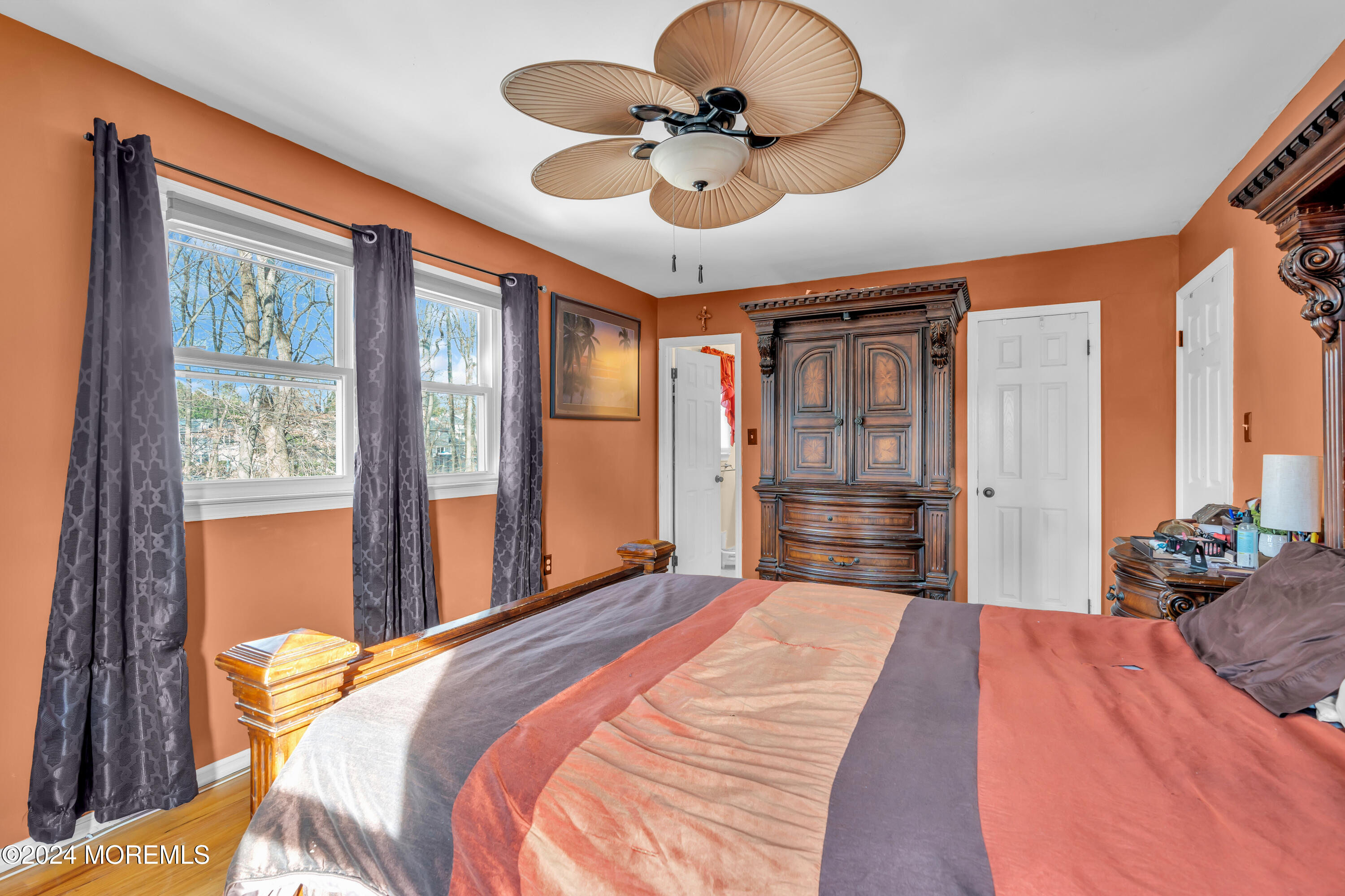50 Hawthorne Road Middletown, NJ 07701 - Photo 19 of 33 a bedroom with a large bed and a chandelier