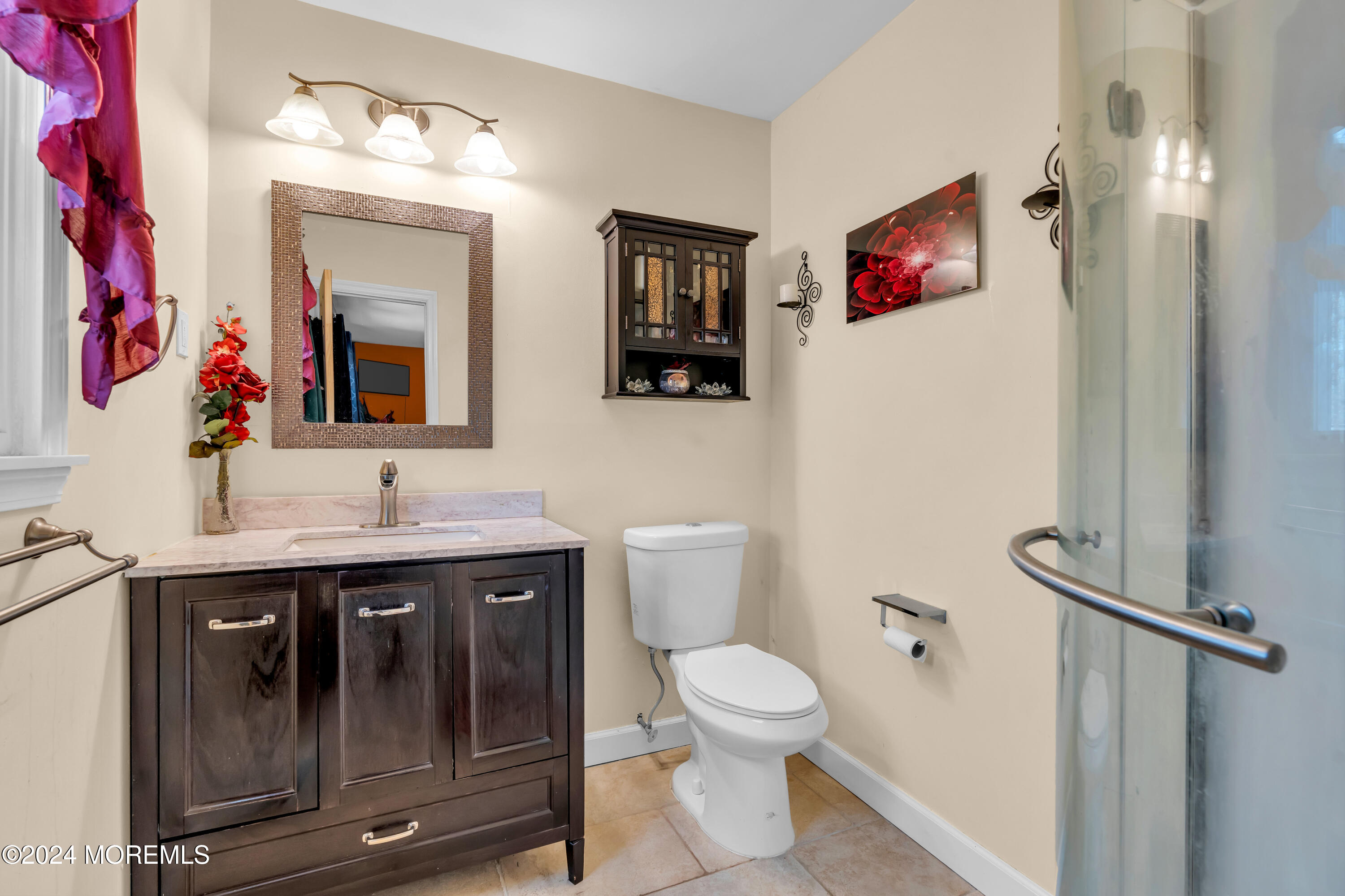 50 Hawthorne Road Middletown, NJ 07701 - Photo 20 of 33 a bathroom with a toilet sink and mirror