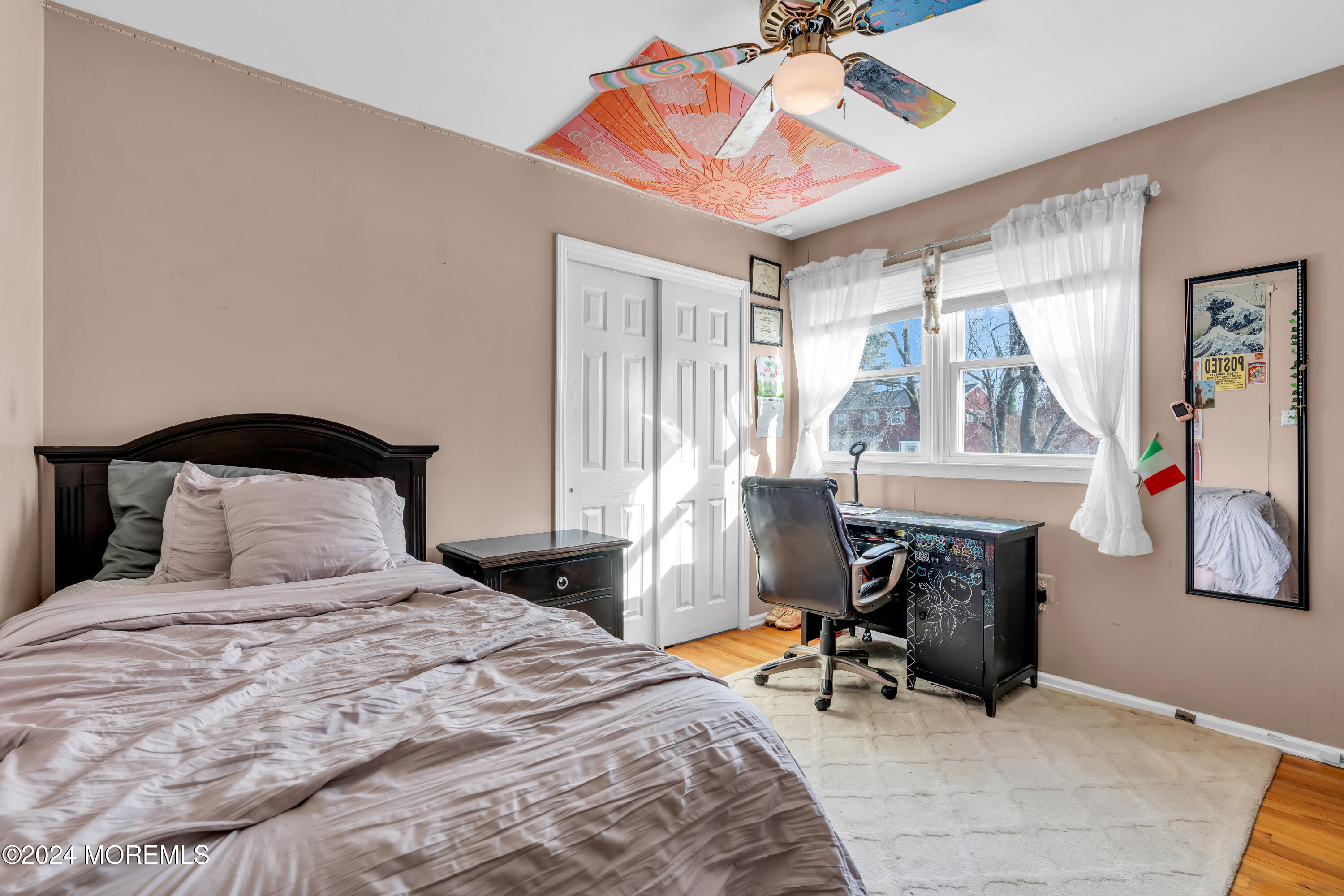 50 Hawthorne Road Middletown, NJ 07701 - Photo 21 of 33 a bedroom with a bed and a chandelier