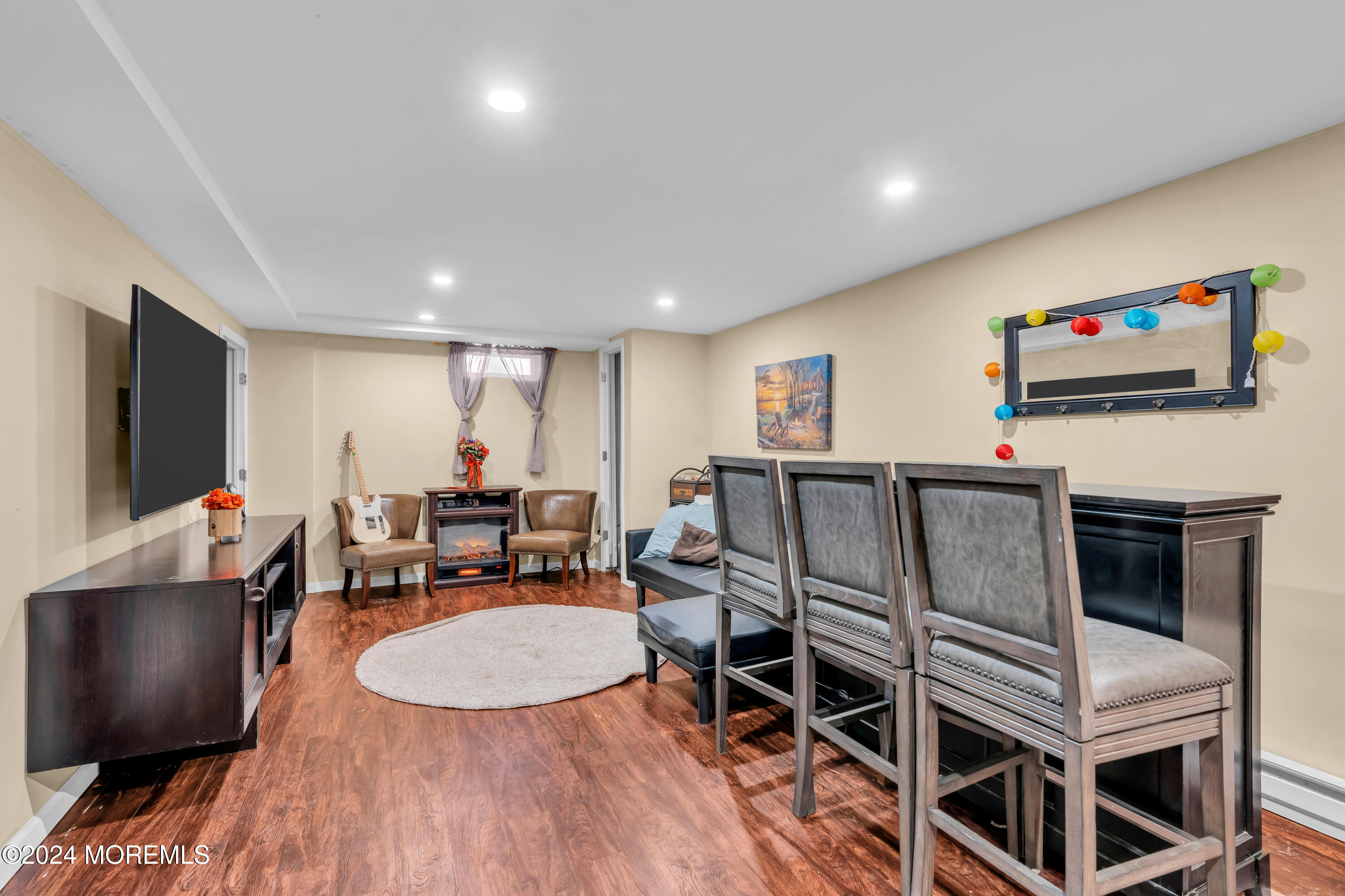 50 Hawthorne Road Middletown, NJ 07701 - Photo 26 of 33 a living room with furniture a flat screen tv and a floor to ceiling window