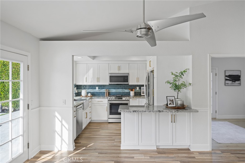 2973 Bonanza San Clemente, CA 92673 - Photo 12 of 41 a view of a kitchen with stainless steel appliances granite countertop a stove top oven a refrigerator a sink and dishwasher with wooden floor