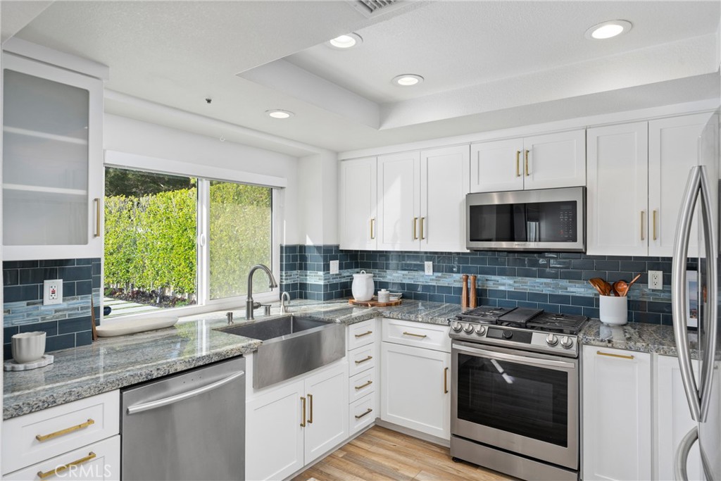 2973 Bonanza San Clemente, CA 92673 - Photo 13 of 41 a kitchen with stainless steel appliances granite countertop a stove a sink and a microwave
