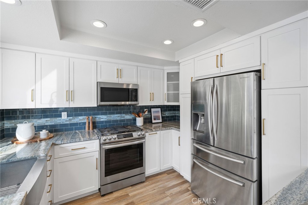 2973 Bonanza San Clemente, CA 92673 - Photo 14 of 41 a kitchen with refrigerator a microwave and cabinets