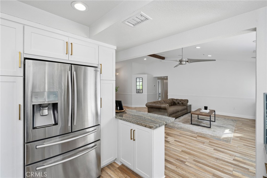 2973 Bonanza San Clemente, CA 92673 - Photo 9 of 41 a kitchen with appliances a refrigerator and cabinets