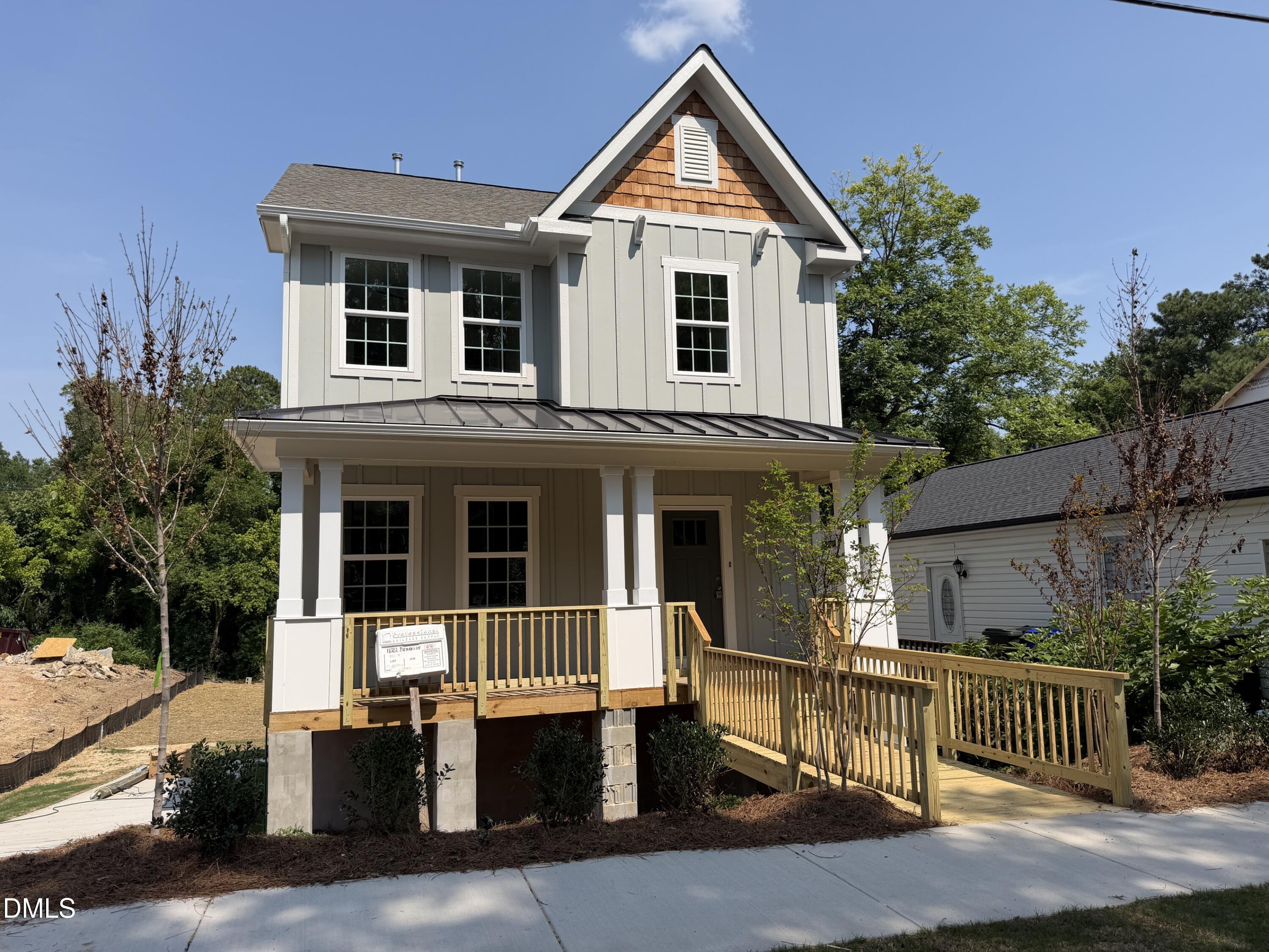 1122 Berkeley Street Durham, NC 27705 - Photo 3 of 29 a view of a white house with large windows and a small yard
