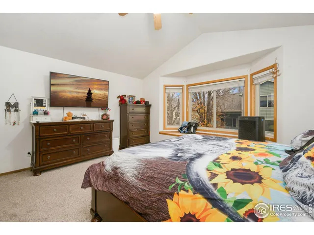 a bedroom with a bed and flat screen tv