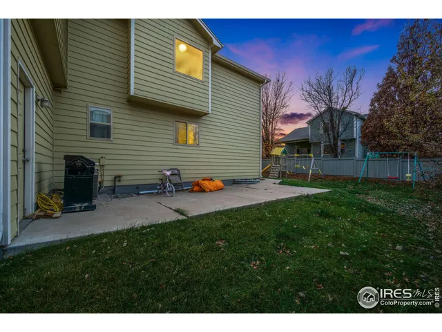 a backyard of a house with table and chairs