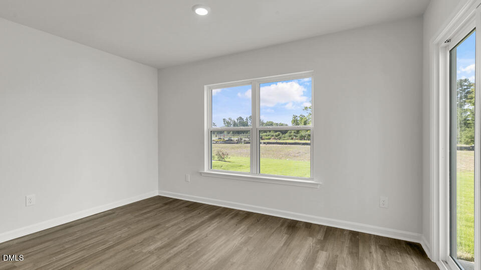 560 Stream Walk Crossing Wendell, NC 27591 - Photo 13 of 41 an empty room with wooden floor and windows