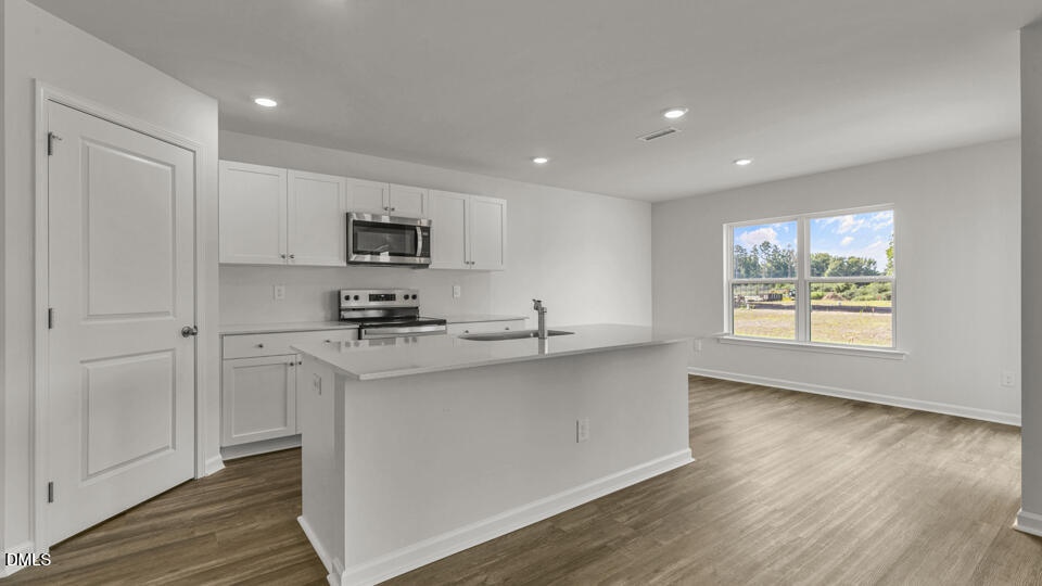 560 Stream Walk Crossing Wendell, NC 27591 - Photo 7 of 41 a kitchen with a sink a window and stainless steel appliances