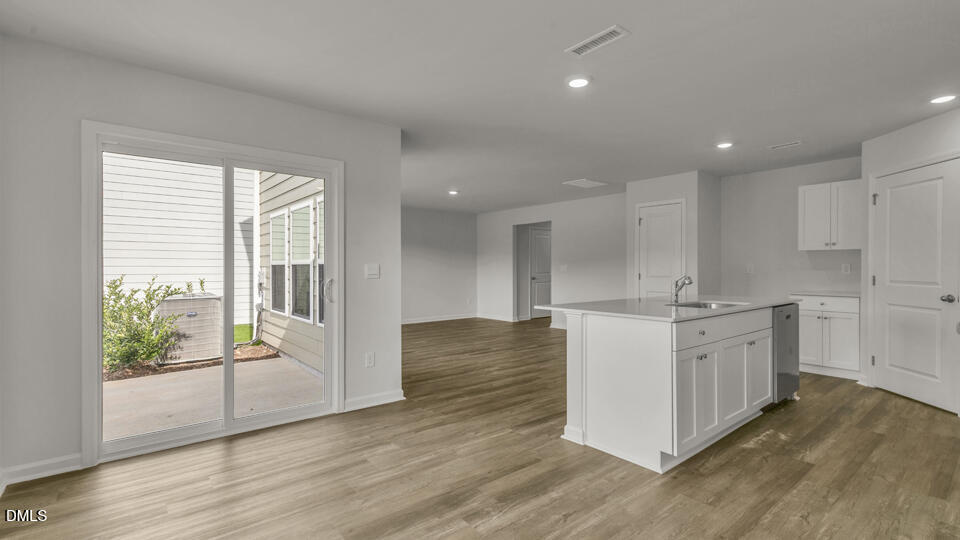 560 Stream Walk Crossing Wendell, NC 27591 - Photo 10 of 41 a large kitchen with stainless steel appliances granite countertop a large counter top and a wooden floors