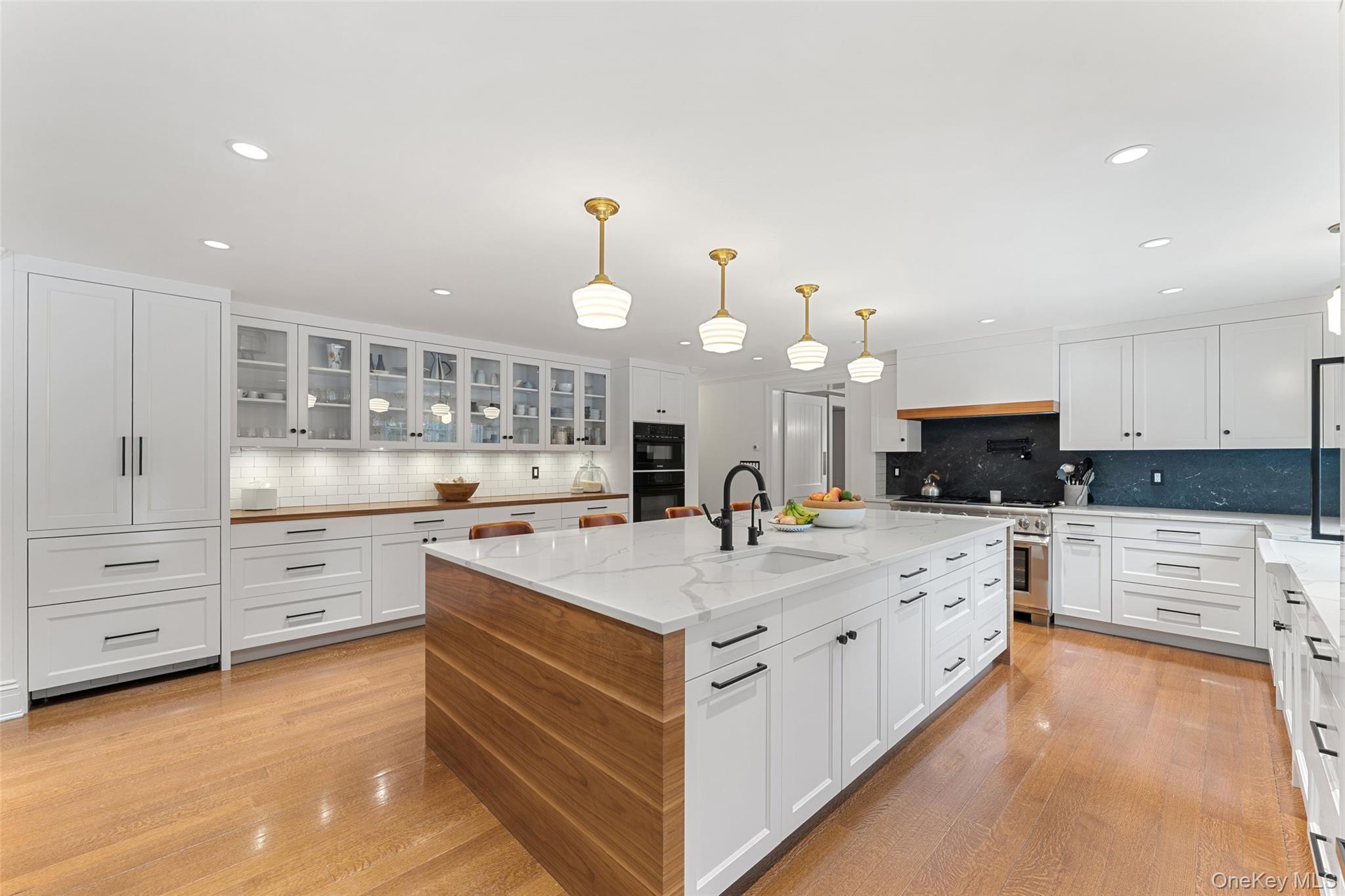 280 Clayton Road Scarsdale, NY 10583 - Photo 5 of 48 Updated kitchen with huge center island with quartz countertops and custom cabinetry and a fleet of upscale appliances