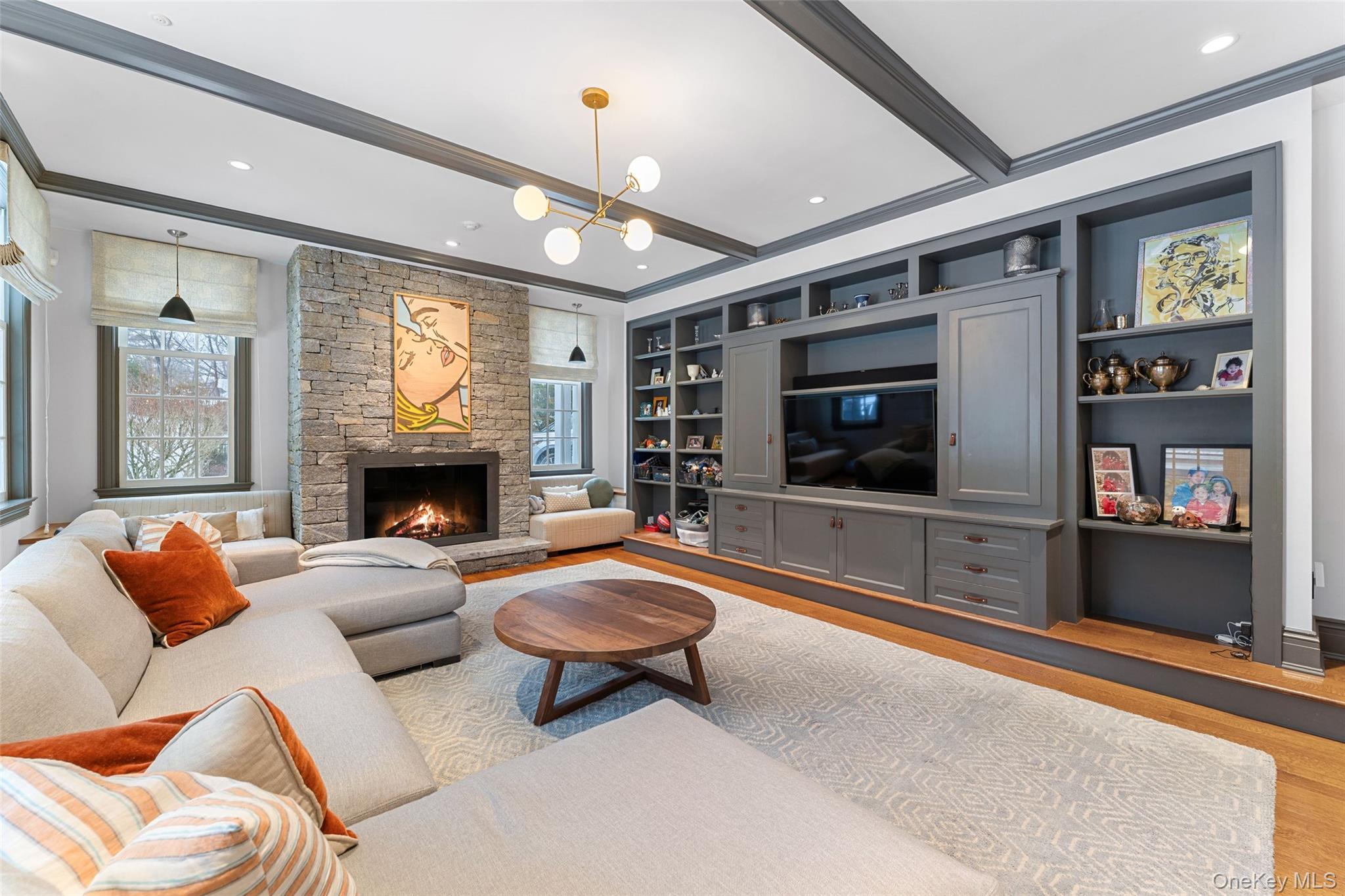280 Clayton Road Scarsdale, NY 10583 - Photo 7 of 48 Family room with custom built in cabinetry and fireplace and beamed ceilings