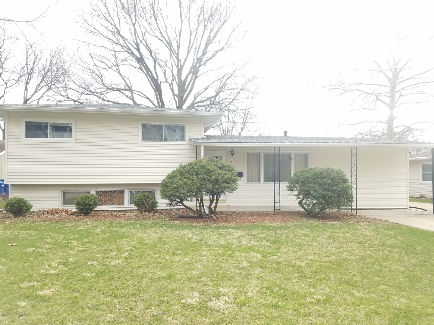 a view of house with backyard and glass windows