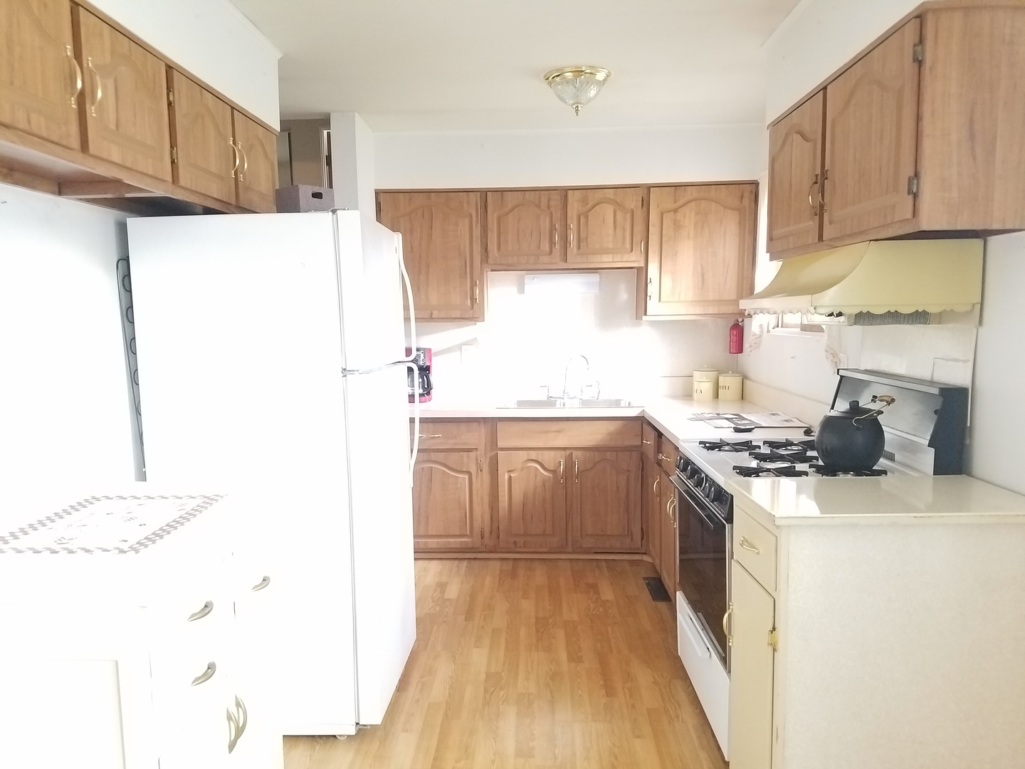 21 Durango Road Montgomery, IL 60538 - Photo 7 of 22 a kitchen with a sink a stove and refrigerator