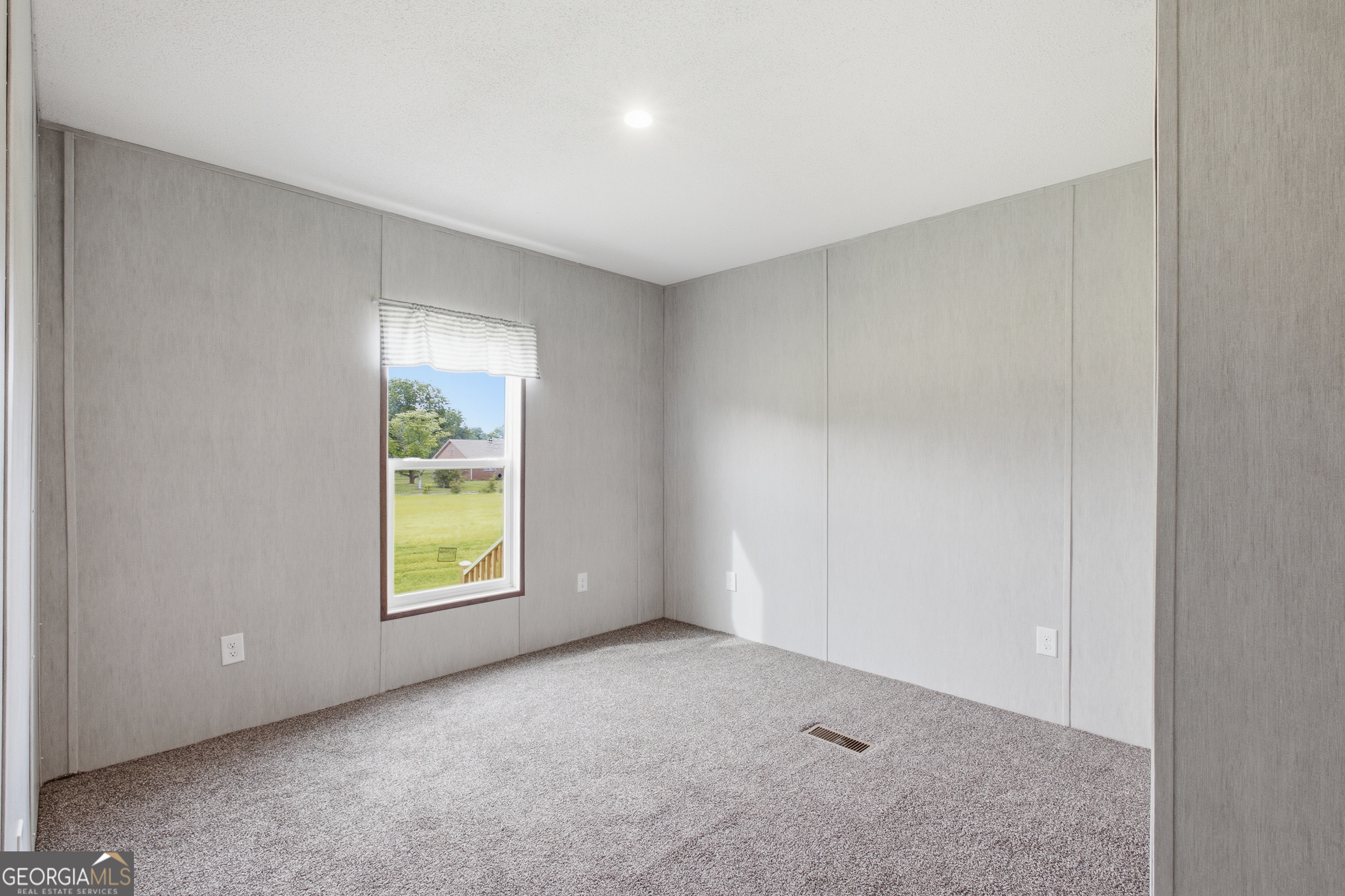244 Ivey Hall Clark Road Garfield, GA 30425 - Photo 27 of 34 an empty room with windows and mirror