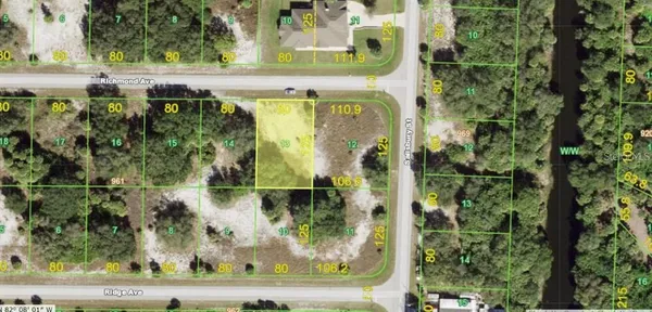 an aerial view of a residential houses with yard