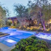 a view of yard with swimming pool and trees