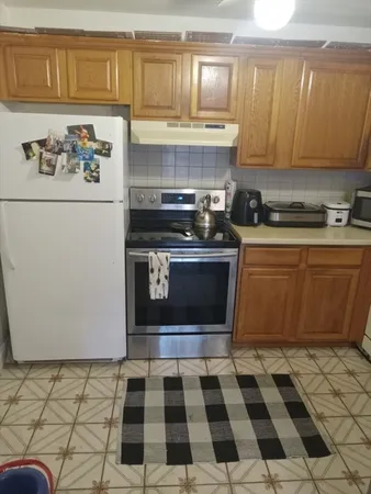 a kitchen with a stove a sink and a microwave