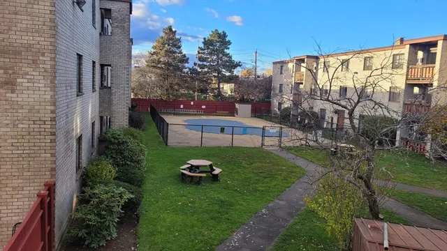 a view of a backyard with plants and outdoor seating