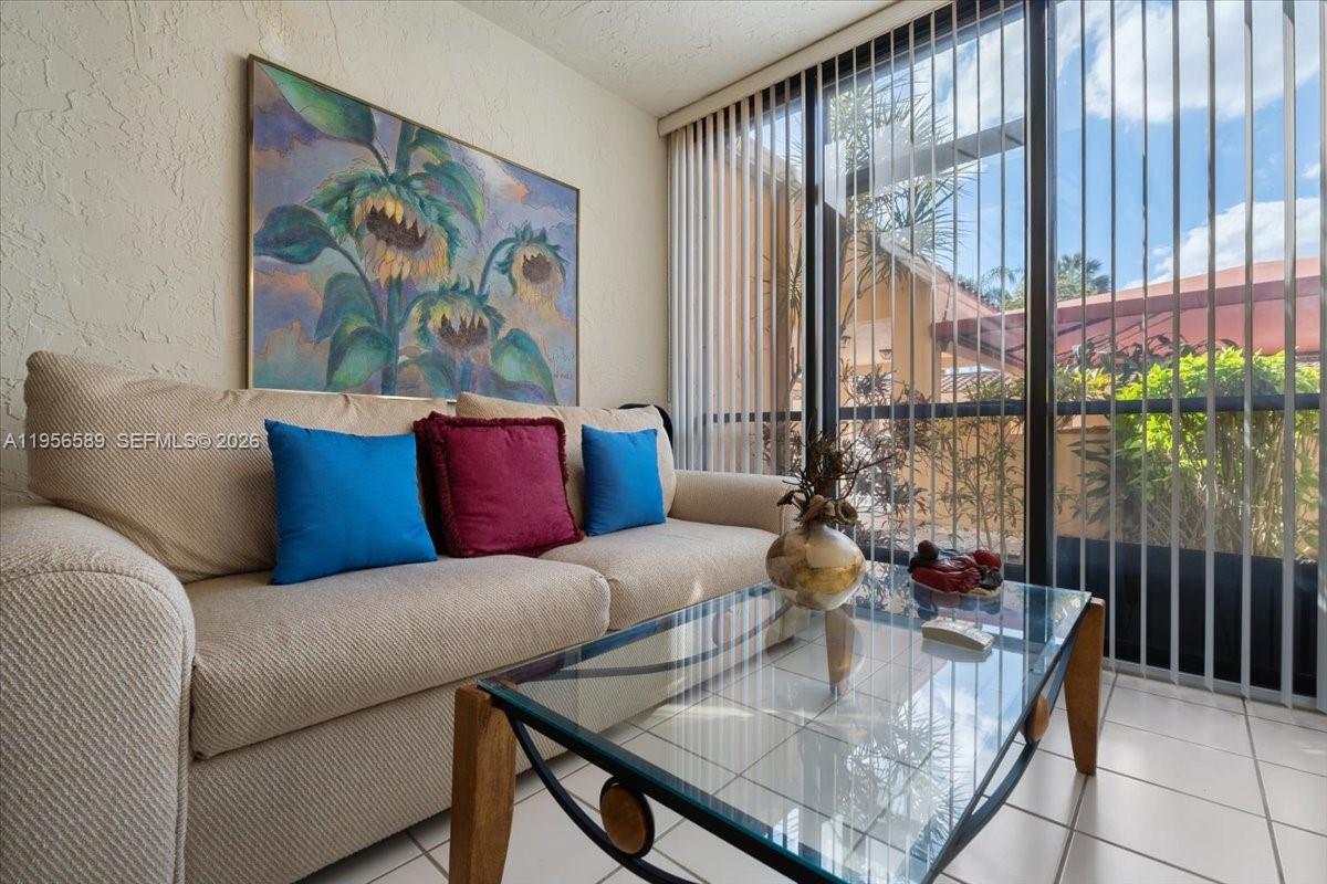 7201 Promenade Drive, Unit 101 Boca Raton, FL 33433 - Photo 12 of 54 a living room with furniture and a large window