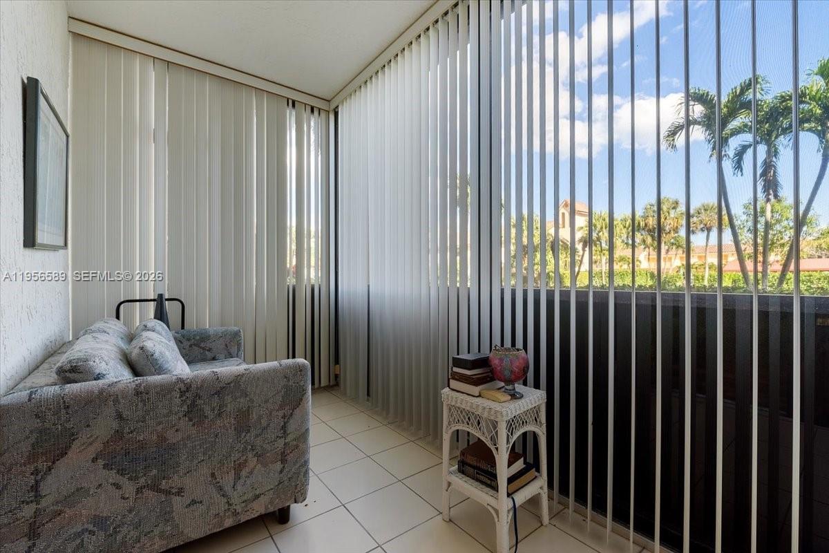 7201 Promenade Drive, Unit 101 Boca Raton, FL 33433 - Photo 15 of 54 a living room with furniture and a potted plant
