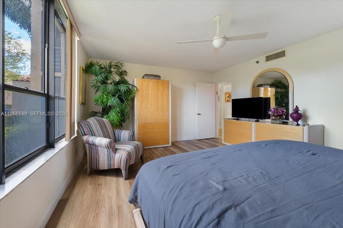 7201 Promenade Drive, Unit 101 Boca Raton, FL 33433 - Photo 22 of 54 a bed room with a bed window and a television