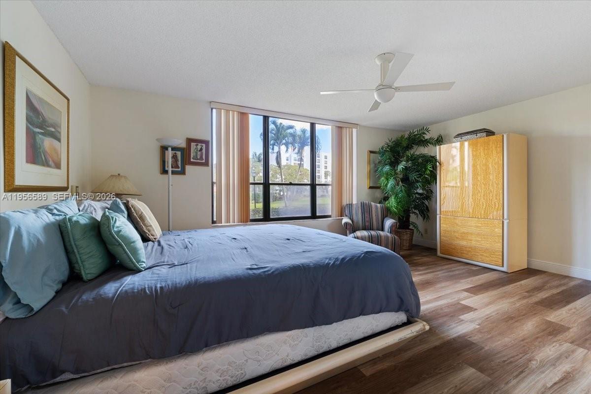 7201 Promenade Drive, Unit 101 Boca Raton, FL 33433 - Photo 23 of 54 a bedroom with a large bed and a window