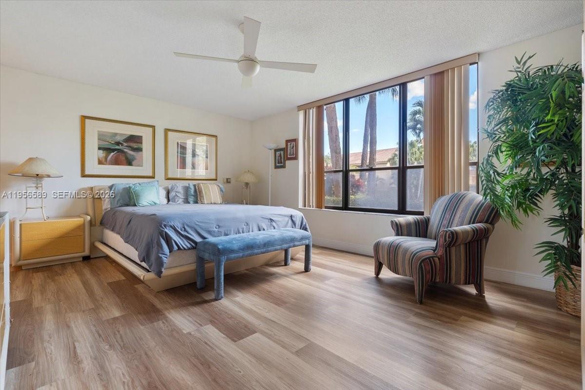 7201 Promenade Drive, Unit 101 Boca Raton, FL 33433 - Photo 25 of 54 a bedroom with a large bed and a large window