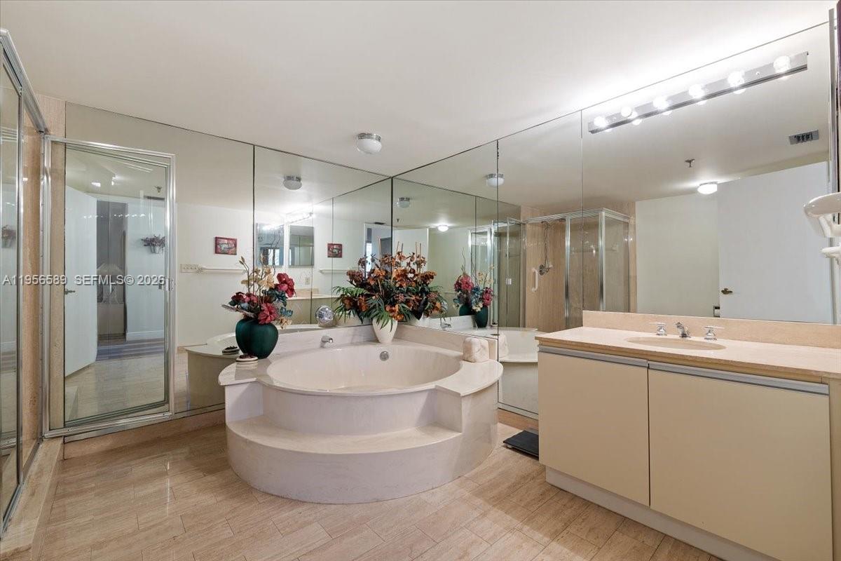 7201 Promenade Drive, Unit 101 Boca Raton, FL 33433 - Photo 28 of 54 a large white kitchen with a white countertops a sink and a large mirror