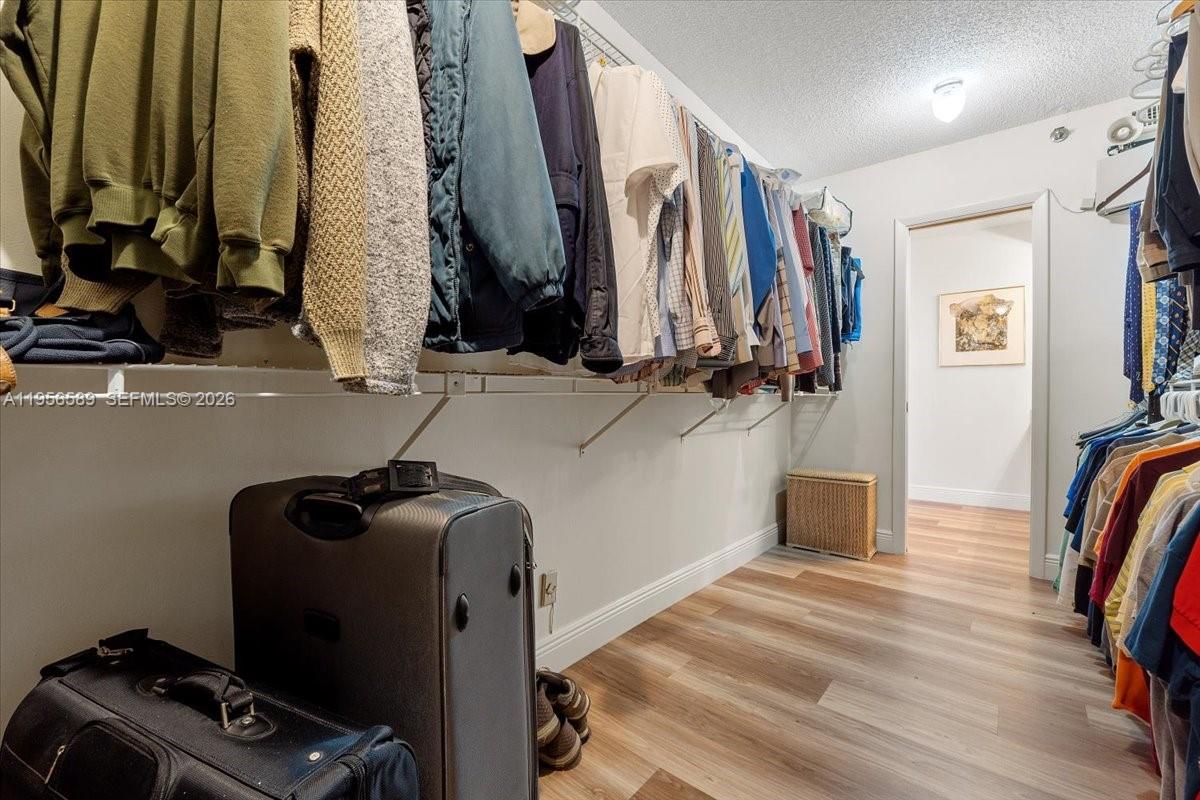 7201 Promenade Drive, Unit 101 Boca Raton, FL 33433 - Photo 31 of 54 a view of walk in closet with clothes and shoes